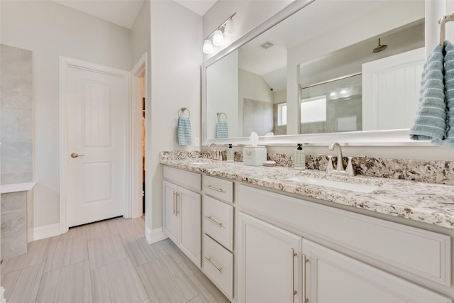 bathroom featuring a shower and vanity