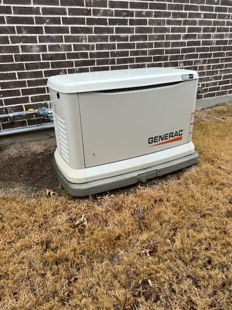 details featuring a power unit and brick siding