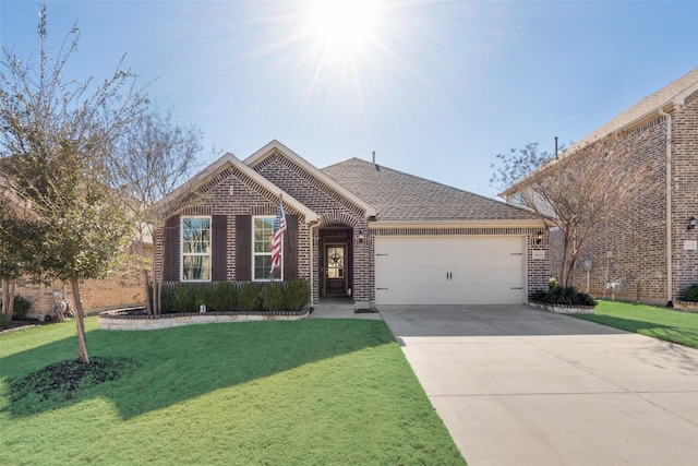 view of front of house with brick siding, a shingled roof, an attached garage, a front yard, and driveway