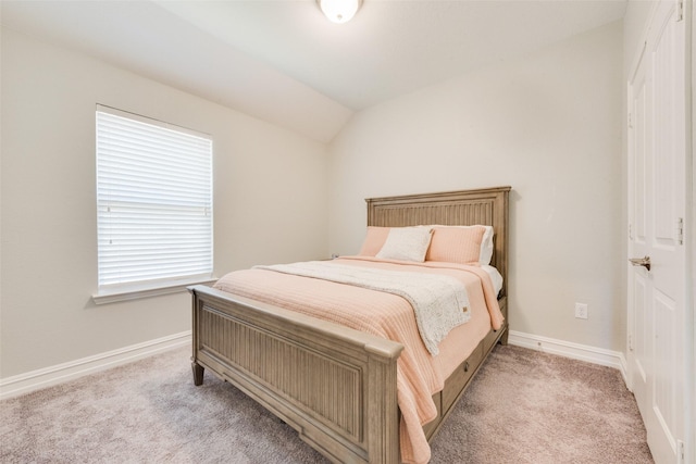 bedroom with light carpet, vaulted ceiling, and multiple windows