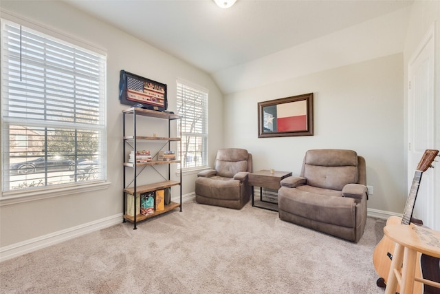 living area featuring carpet, lofted ceiling, and baseboards