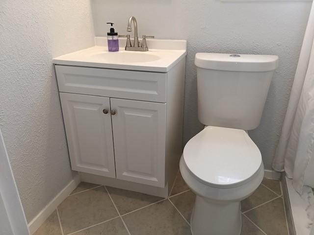 bathroom featuring vanity, tile patterned flooring, curtained shower, and toilet