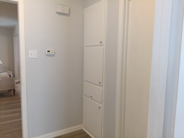 hallway with hardwood / wood-style flooring