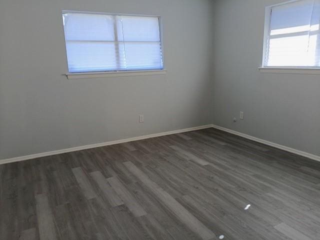 spare room featuring dark wood-type flooring