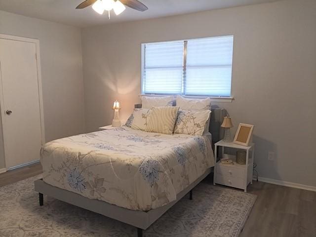 bedroom with wood-type flooring and ceiling fan