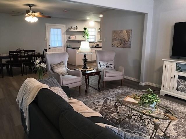 living room with dark hardwood / wood-style floors and ceiling fan