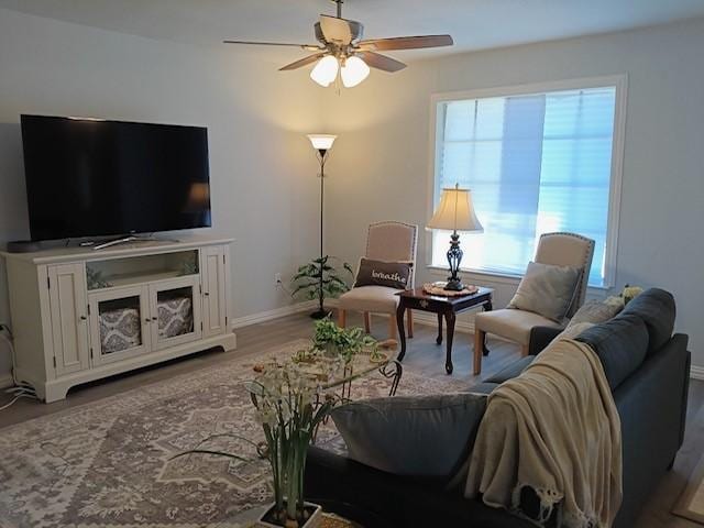 living room with ceiling fan and light wood-type flooring