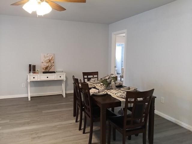 dining space featuring ceiling fan and dark hardwood / wood-style floors