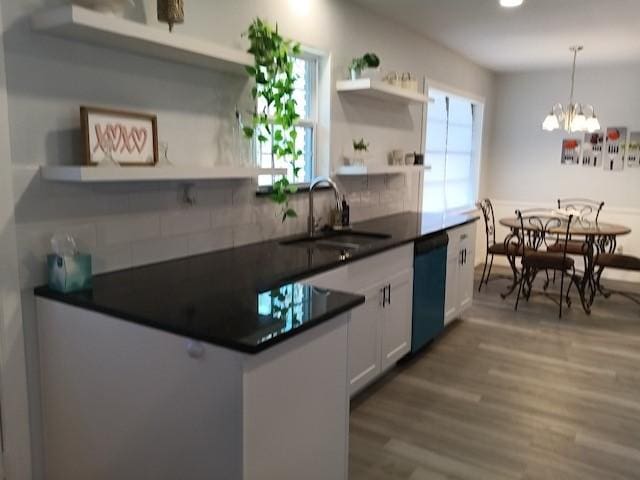 kitchen with sink, dishwasher, hardwood / wood-style floors, tasteful backsplash, and white cabinets