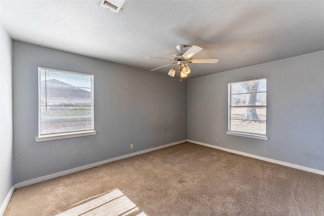 carpeted spare room with ceiling fan