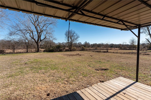 view of yard with a wooden deck and a rural view