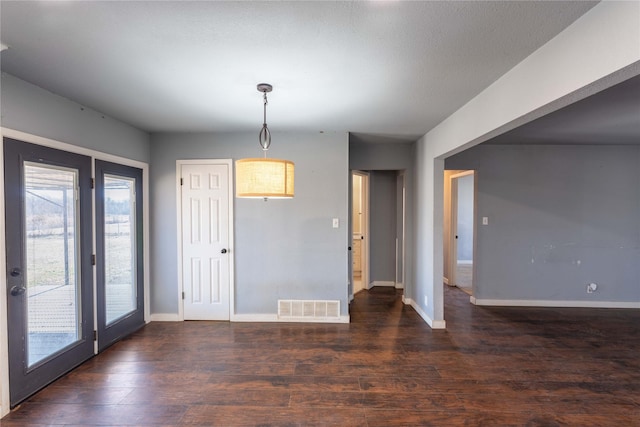 unfurnished dining area featuring dark hardwood / wood-style floors