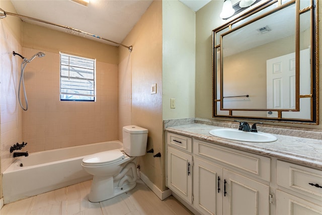 full bathroom featuring tiled shower / bath combo, vanity, tile patterned floors, and toilet