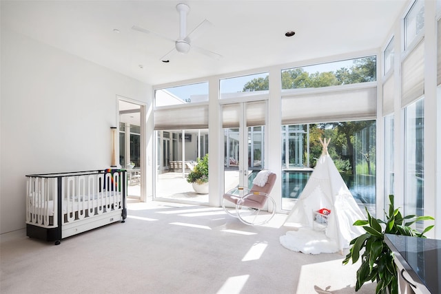 sunroom / solarium featuring ceiling fan