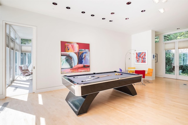 game room featuring billiards, floor to ceiling windows, and light wood-type flooring