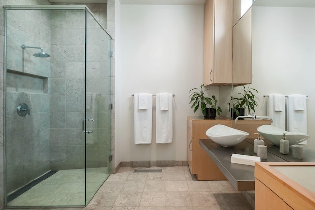 bathroom featuring vanity and an enclosed shower