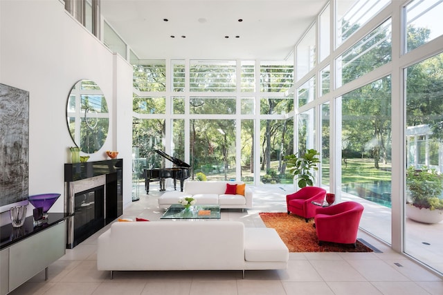 sunroom featuring a high end fireplace