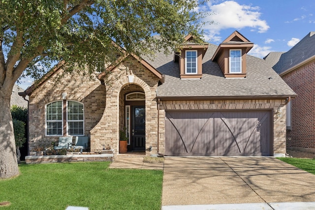 view of front of home featuring a garage and a front lawn