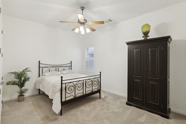 bedroom featuring light colored carpet and ceiling fan