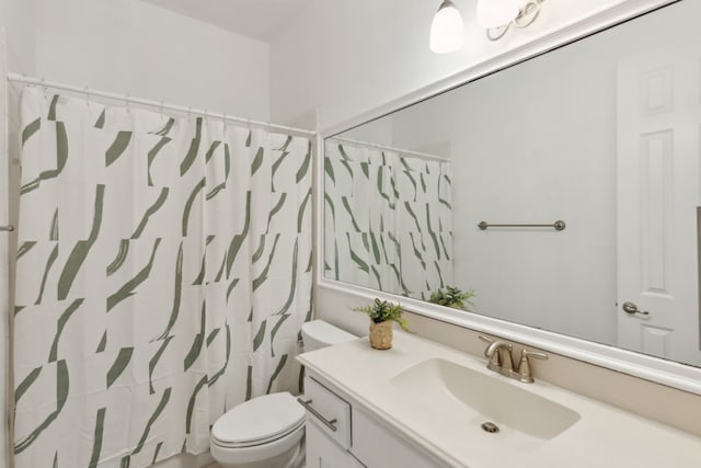 bathroom with a shower with curtain, vanity, and toilet