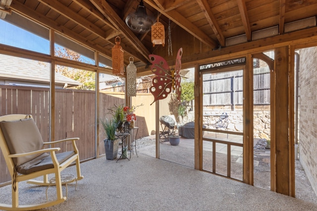 unfurnished sunroom featuring wood ceiling and vaulted ceiling with beams