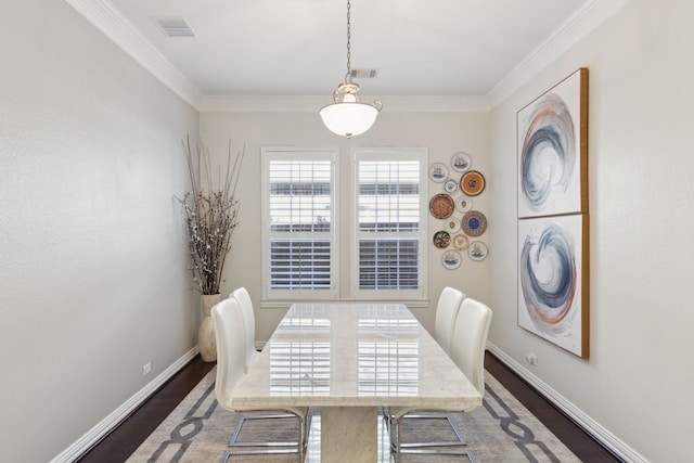 dining area with dark wood-type flooring and ornamental molding