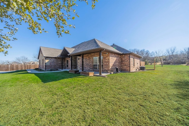 view of side of home featuring central AC and a lawn