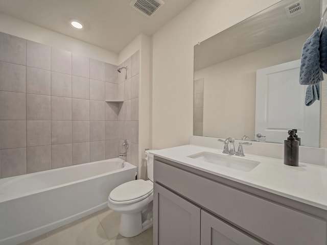 full bathroom featuring tile patterned flooring, vanity, toilet, and tiled shower / bath