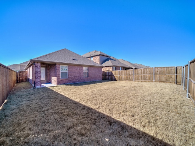 back of house with a lawn