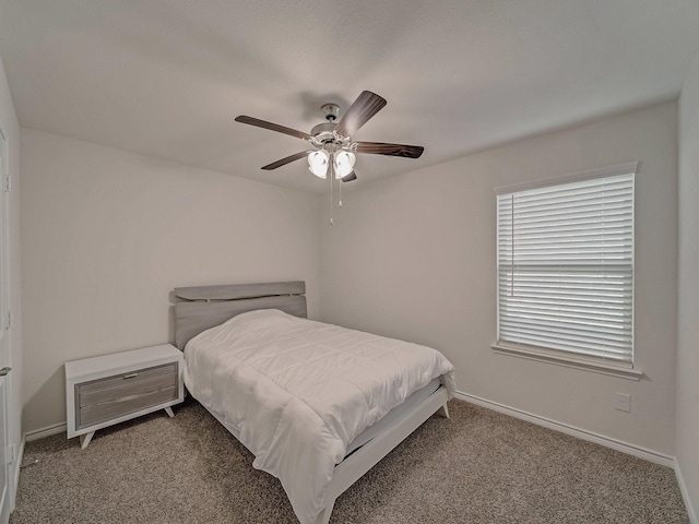 bedroom featuring ceiling fan and carpet