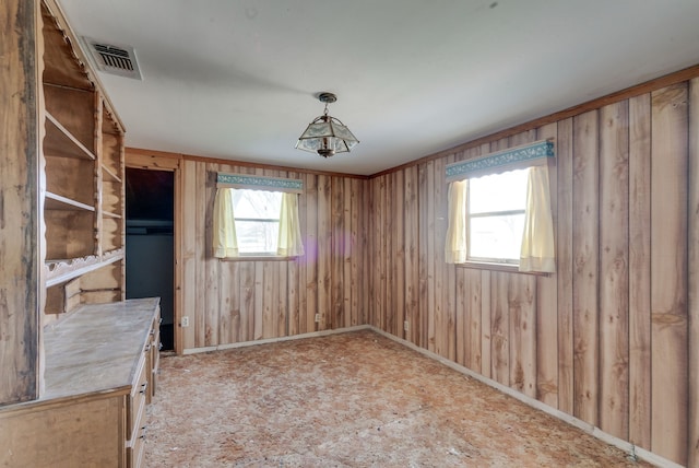 empty room featuring wooden walls