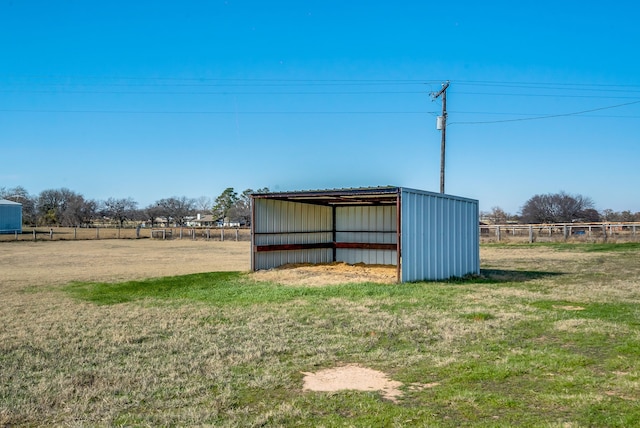 view of outbuilding with a yard and a rural view