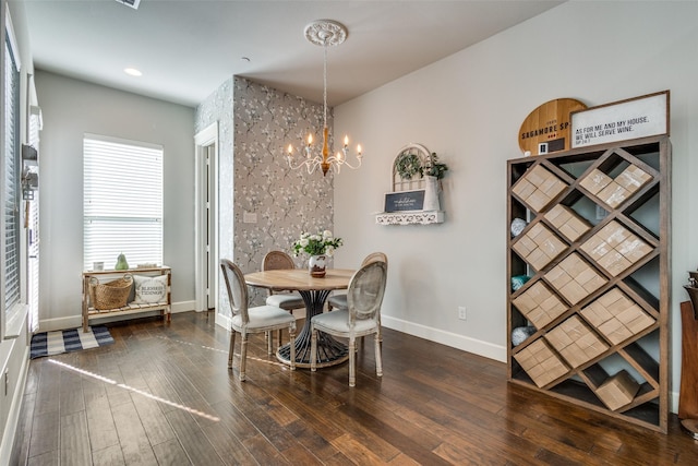 dining area with an inviting chandelier and dark wood-type flooring