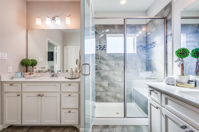 bathroom featuring vanity and a shower with door