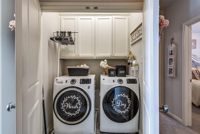 laundry room with cabinets, washer and dryer, and light colored carpet