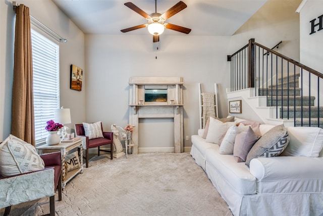 carpeted living room with ceiling fan