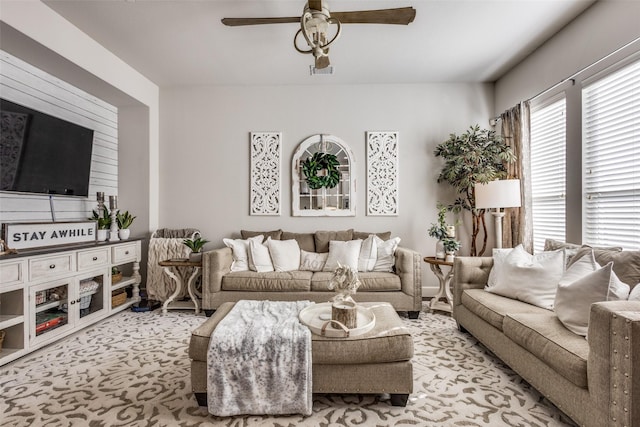 carpeted living room with ceiling fan