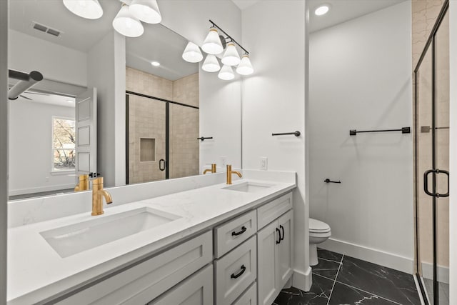 bathroom with a shower with door, vanity, and toilet