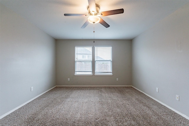 empty room featuring ceiling fan and carpet