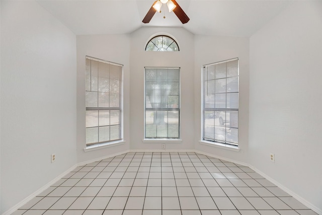 tiled empty room featuring lofted ceiling and ceiling fan