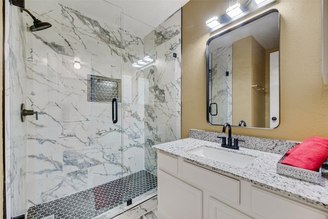 bathroom featuring walk in shower and vanity