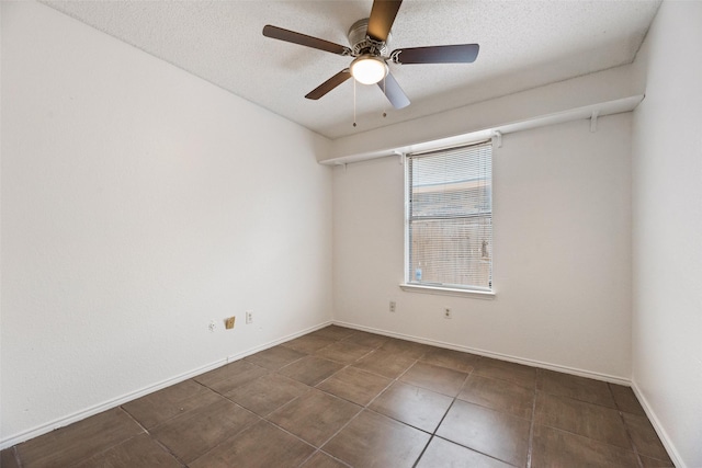 unfurnished room with ceiling fan and a textured ceiling