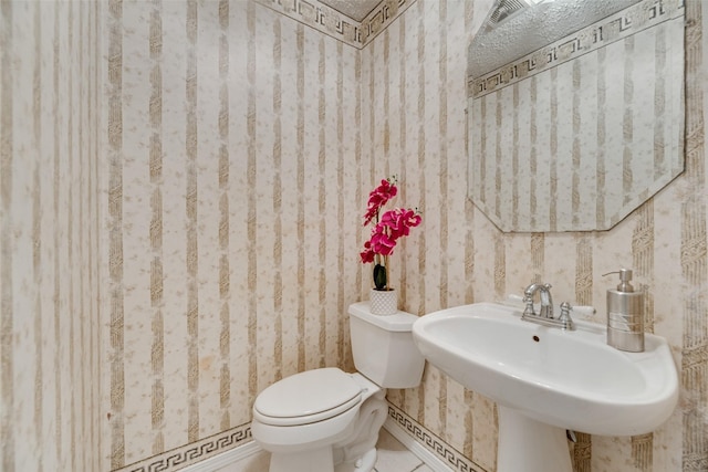 bathroom with tile patterned floors, toilet, and sink