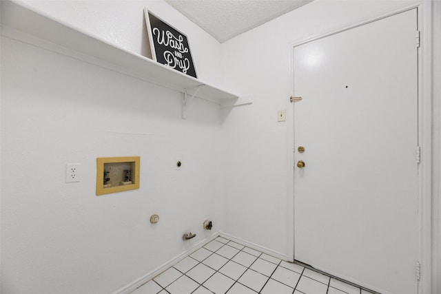 washroom with gas dryer hookup, light tile patterned floors, electric dryer hookup, washer hookup, and a textured ceiling