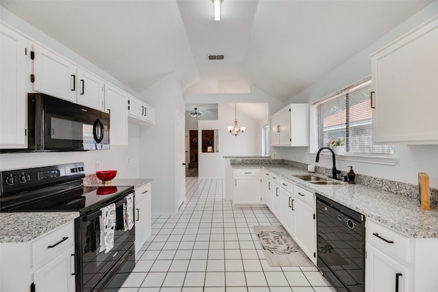 kitchen featuring sink, light tile patterned floors, white cabinetry, black appliances, and vaulted ceiling