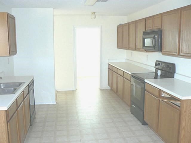 kitchen featuring sink and black appliances