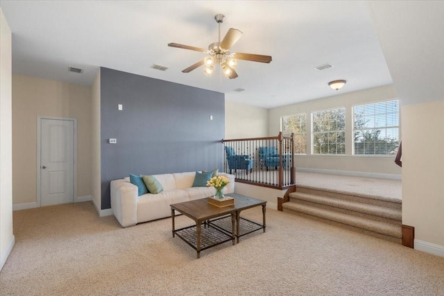 carpeted living room with ceiling fan