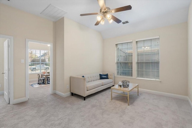 living area featuring lofted ceiling, light carpet, and ceiling fan