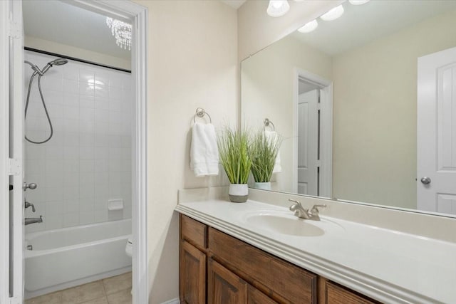 full bathroom featuring vanity, toilet, tiled shower / bath combo, and tile patterned flooring