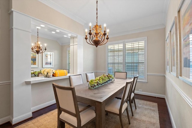 dining room featuring dark wood-type flooring, crown molding, and an inviting chandelier